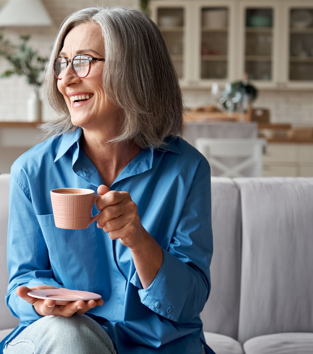 Woman drinking tea/coffee on sofa