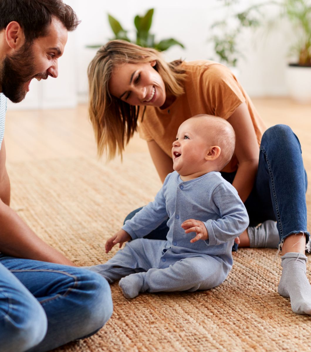 Mother and father playing with their baby