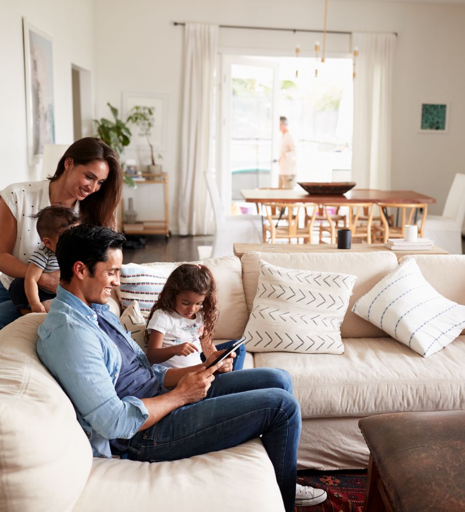 Mother and father in living room with two children