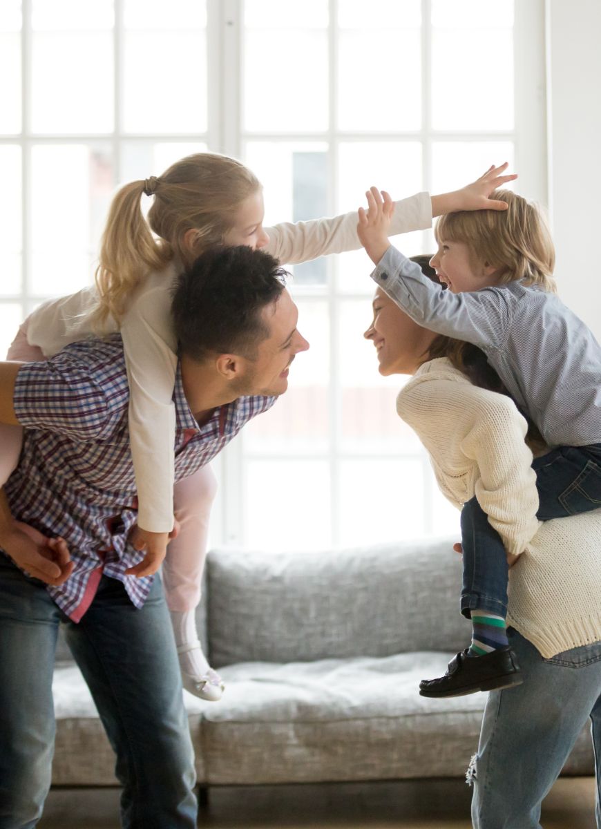 Mother and father playing with son and daughter